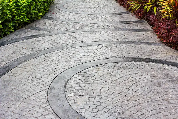 An elegant stamped concrete walkway with curved patterns crafted by Northland Concrete’s decorative concrete specialists.