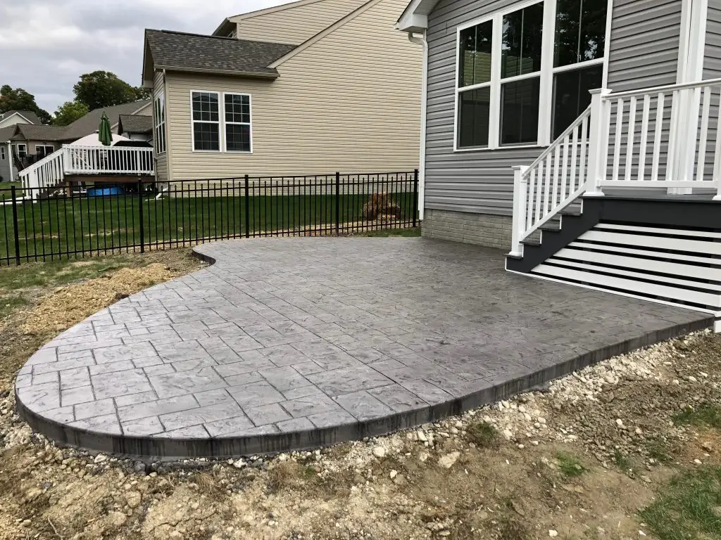 Create a stunning backyard oasis with Northland Concrete’s paver patios, featuring a cozy fire pit and seating area.