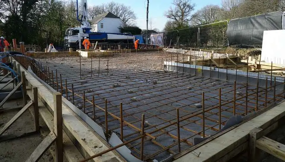 Pouring concrete over rebar for a strong foundation at Northland Concrete Foundations.