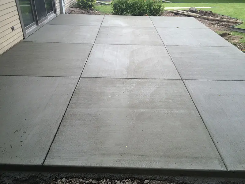 This stamped concrete patios by Northland Concrete showcases an intricate border design for a sophisticated outdoor look.