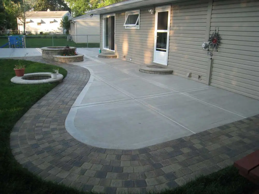 Transform your outdoor space with Northland Concrete’s stone patios, blending beautifully with lush landscaping.