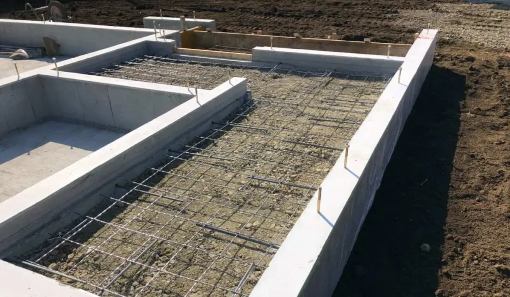 Wet concrete footing with support column by Northland Concrete Foundations.